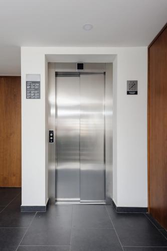 a elevator in an office building with a metal door at Majestic 1BR with Balcony in Cuauhtémoc in Mexico City