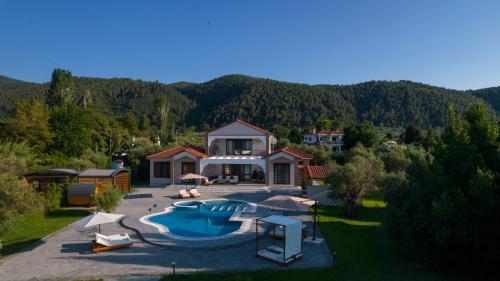 an aerial view of a house with a swimming pool at Epavli Alexandros Luxury Villa in Vourvourou