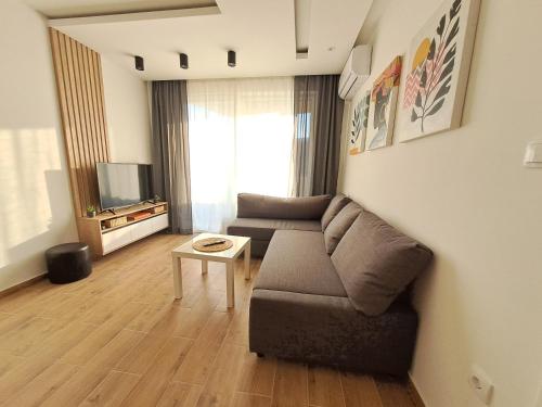 a living room with a couch and a table at Apartman 64 Lux in Veliko Gradište