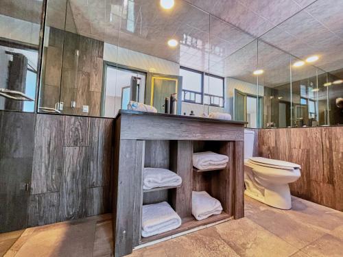 a bathroom with a wooden counter and a toilet at Hotel Casa Real Cholula in Cholula