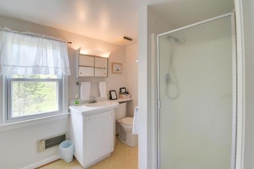 baño con aseo y lavabo y ventana en Historic Countryside Escape - Relax, Hike, & Fish!, en Goshen