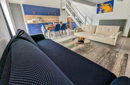a living room with a couch and a table at Gite Grand Luberon chez Manon en Luberon - Vacation rental in guest house in Lagnes