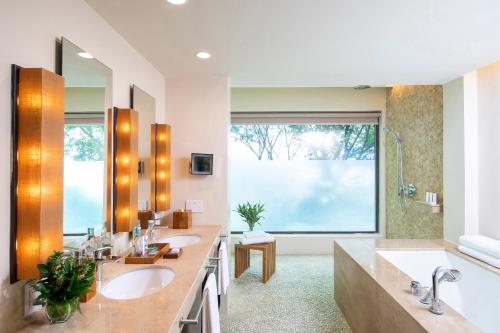 a bathroom with two sinks and a large window at Andaz Costa Rica Resort at Peninsula Papagayo – A concept by Hyatt in Culebra