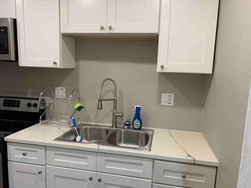 a kitchen with a sink and white cabinets at Apartment in Daytona Beach 1BR 1Bath Centrally Located in Daytona Beach