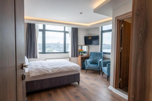 a hotel room with a bed and a chair and window at Han Residence Haliç in Istanbul