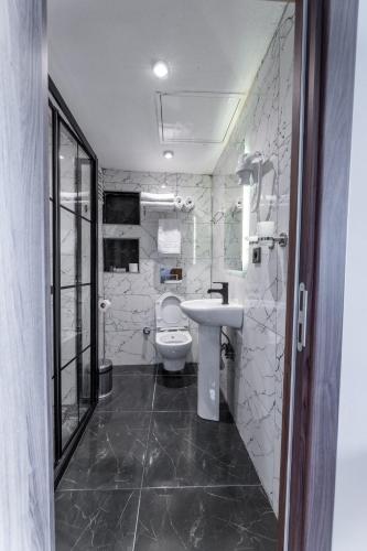 a bathroom with a white toilet and a sink at Han Residence Haliç in Istanbul