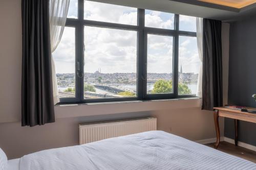 a bedroom with a large window with a view at Han Residence Haliç in Istanbul