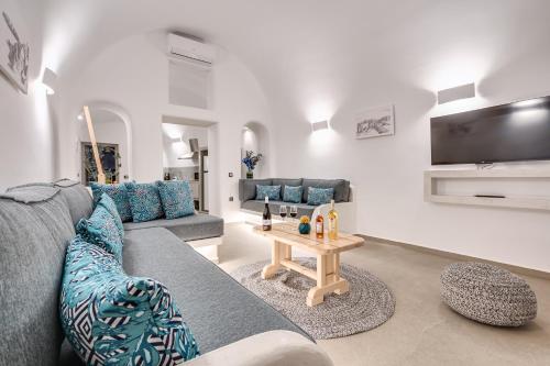a living room with a couch and a table at Tiara Suites Santorini in Fira