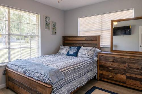 a bedroom with a bed and a dresser and a mirror at Clark House Perfect for Workers! in Orange
