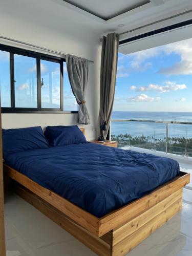 a bedroom with a large bed with a view of the ocean at Villa Ocean Blue in Las Terrenas
