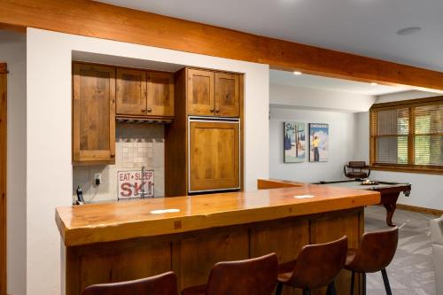 a kitchen with wooden cabinets and a counter top at The Porches in Steamboat Springs