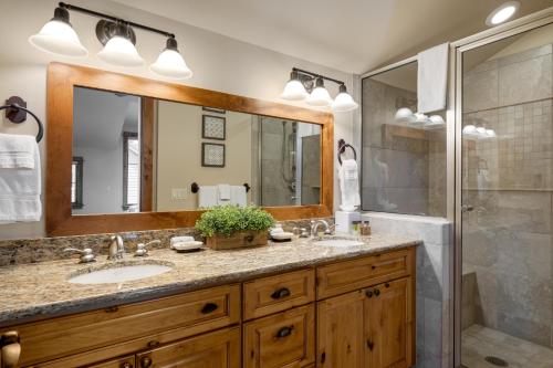 a bathroom with two sinks and a shower at The Porches in Steamboat Springs