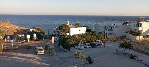 a group of cars parked in a parking lot near the ocean at Lentas Royal in Léntas