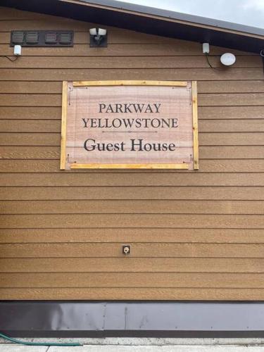 a sign on the wall of a guest house at ParkWay Yellowstone Guest House Apartment #3 in Gardiner