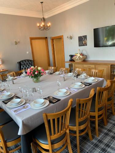 a conference room with a long table and chairs at Chandlers Country House in Rothesay