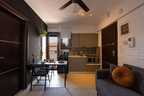 a kitchen and living room with a couch and a table at Upper city suite in Thessaloniki
