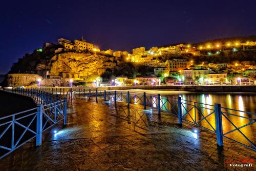 a view of a city at night with a mountain at Casa Francesco in Pizzo