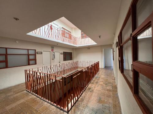 an empty hallway with a balcony in a building at HOTEL VILLAGRAN in Tijuana