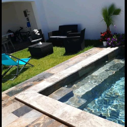 a backyard with a swimming pool and a living room at LaVillaEden13 in Gignac-la-Nerthe