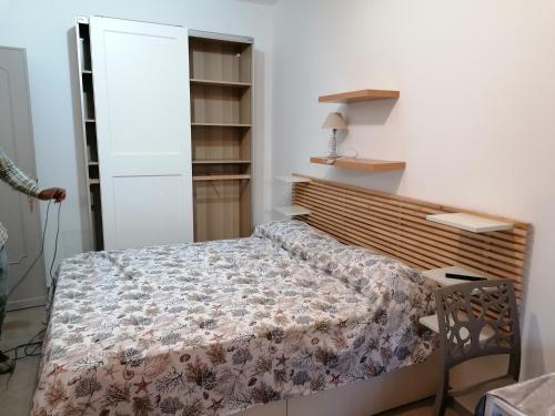 a bedroom with a bed in a room with shelves at Casa vacanze Lido delle Sirene in Anzio