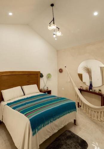 a bedroom with a bed and a large mirror at Departamento amplio, privado y completo in Valladolid
