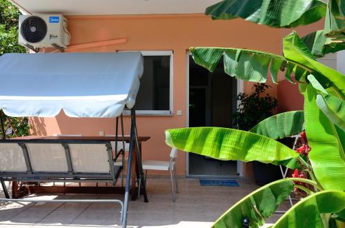 a table and a chair in front of a house at Villa Ektoras by EY Villas in Parga