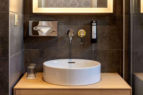 a bathroom with a white sink in a room at Best Western Plus Monopole Métropole in Strasbourg