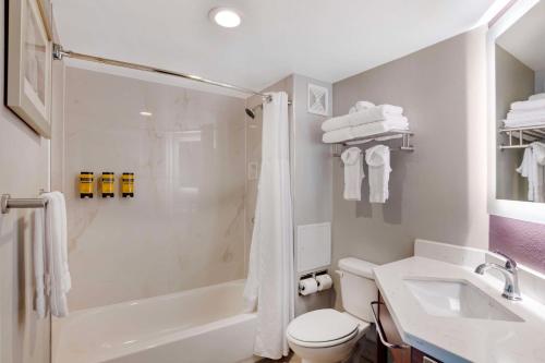 a bathroom with a shower and a toilet and a sink at Best Western Plus Commerce Hotel in Los Angeles