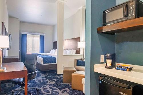 a small hotel room with a bed and a room at Comfort Inn & Suites Oklahoma City South I-35 in Oklahoma City