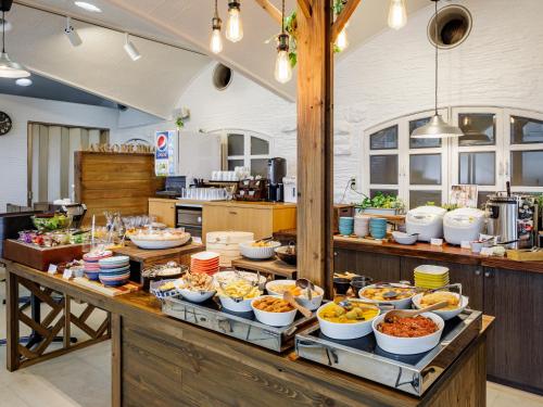a buffet with many bowls of food on a table at APA Hotel Nagasaki Dejima in Nagasaki