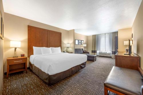 a large hotel room with a bed and a couch at Comfort Inn & Suites Orem - Provo in Orem