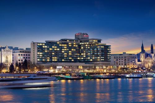 a large building next to a river at night at Budapest Marriott Hotel in Budapest