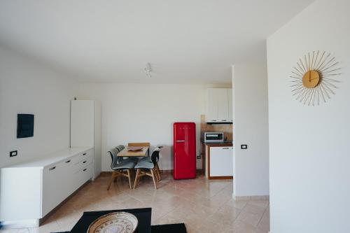 a kitchen with a red refrigerator and a table at Villa Alba Sul Mare in Budoni