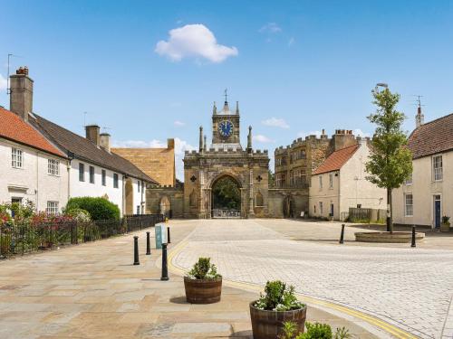 an empty street in a town with a clock tower at Number Two - Uk44865 in Bishop Auckland