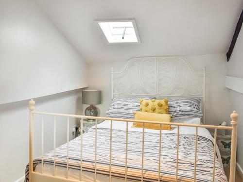 a bedroom with a white bed in a room at The Old Buttery in Chulmleigh