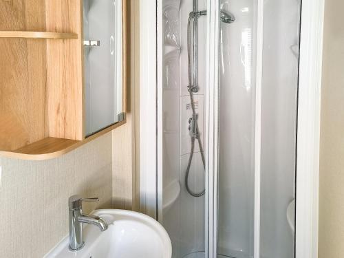 a bathroom with a sink and a shower at 32 Skelmorlie in Skelmorlie
