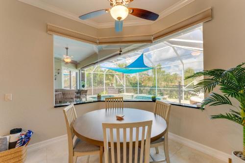 a dining room with a table and chairs and a window at Grill-Chill-Splash Your Port Charlotte Paradise! in Port Charlotte