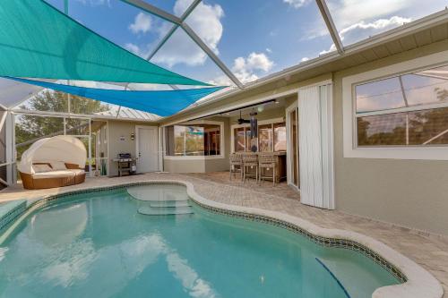 a swimming pool in a house with a glass ceiling at Grill-Chill-Splash Your Port Charlotte Paradise! in Port Charlotte