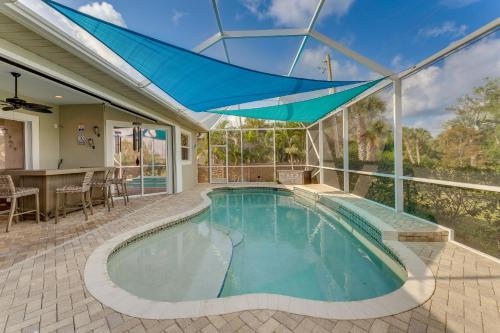 an indoor swimming pool with a large glass ceiling at Grill-Chill-Splash Your Port Charlotte Paradise! in Port Charlotte