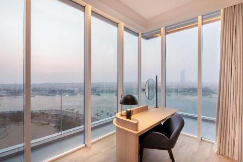 an office with a desk and large windows at Four Points by Sheraton Jeddah Corniche in Jeddah