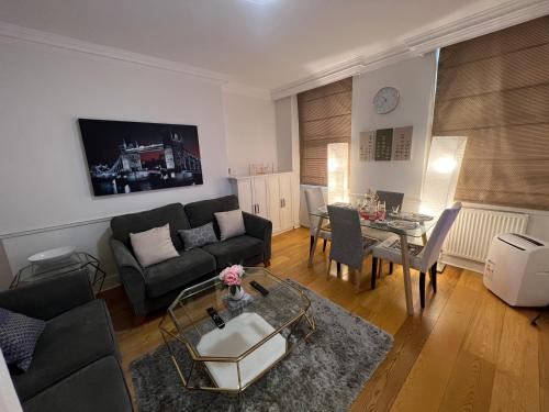 a living room with a couch and a table at Luxurious 2 bedroom apartment in Central London in London