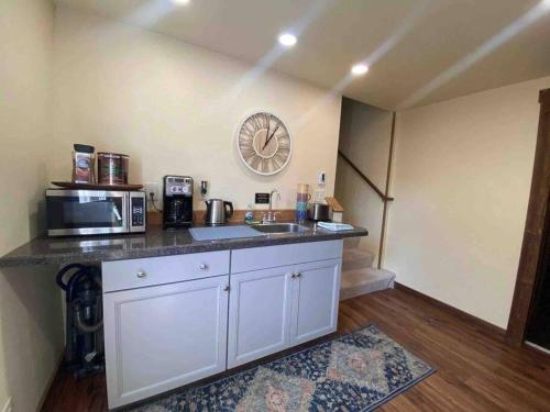 cocina con fregadero y microondas en Parkway Yellowstone Guest House Apartment #5 en Gardiner