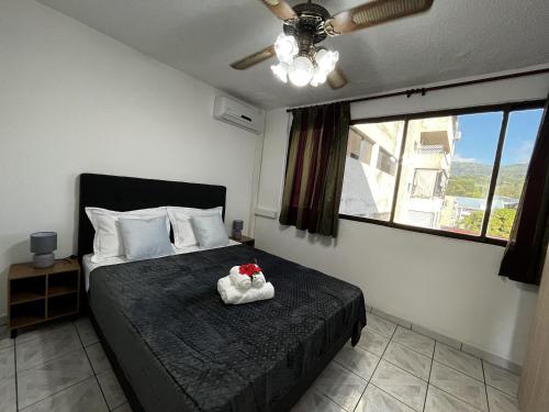 a bedroom with a bed with two stuffed animals on it at NEW My Lodge - Parking, AC, Netflix & Wifi in Papeete