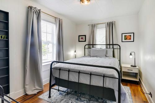 a bedroom with a bed and a window at Cozy Starkville Apartment Walk to Main Street! in Starkville