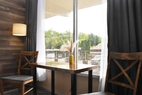 a table and two chairs in a room with a window at Timber Ridge Lodge - Walking Distance from Downtown Gatlinburg in Gatlinburg