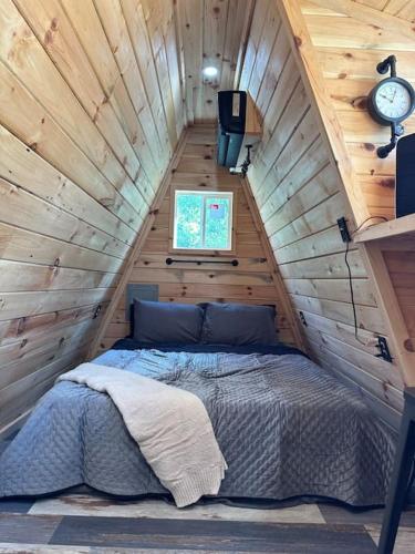 a bedroom with a bed in a wooden attic at Acres Away in Penn Yan