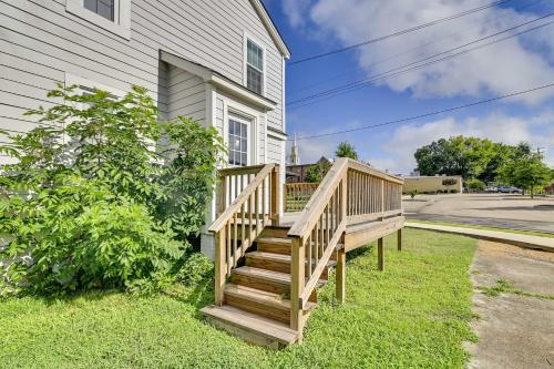 a house with a wooden staircase next to a house at Charming Abode about 2 Mi to Mississippi State Campus! in Starkville