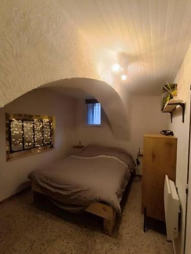 a bedroom with a bed and a window in it at Appartement avec jacuzzi in Saint-Maximin-la-Sainte-Baume