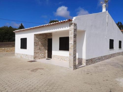 a small white house with a brick at Casa Manuel J. J. M -Alfambras, Aljezur - Quiet Country House in Aljezur