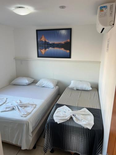 מיטה או מיטות בחדר ב-Lindo flat sem custos adicionais